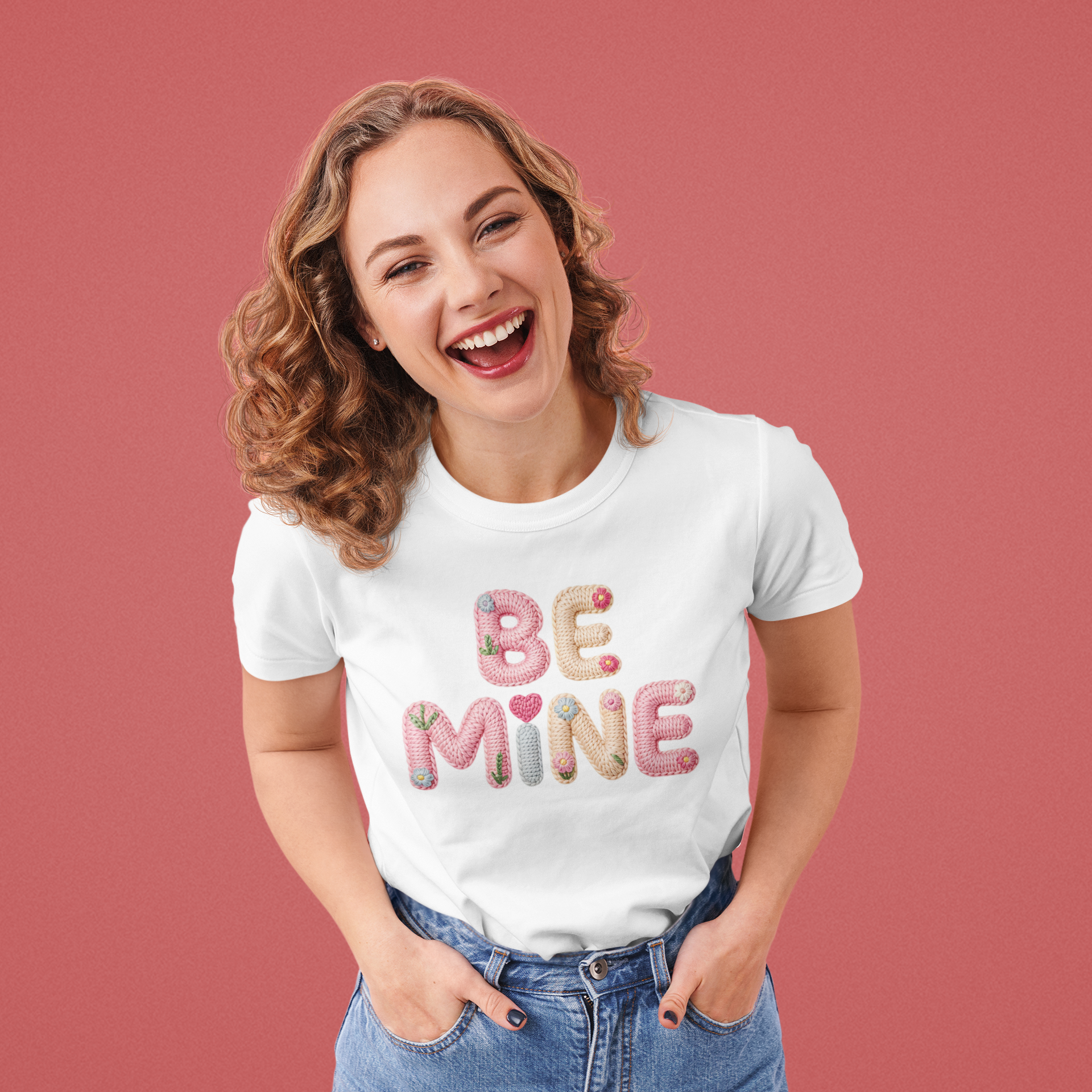 Woman wearing a white t-shirt with 'BE MINE' text on a pink background