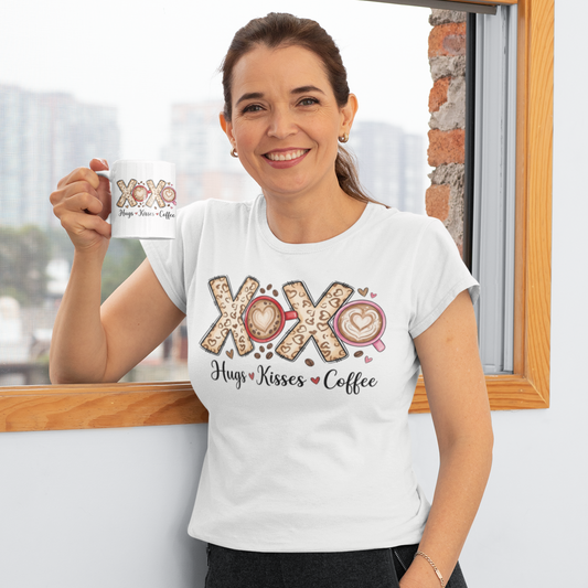 Woman wearing a white t-shirt with 'XOXO Hugs & Kisses Coffee' design, holding a mug.